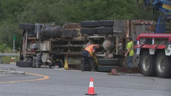 Driver walks way after garbage truck rolls over his legs
