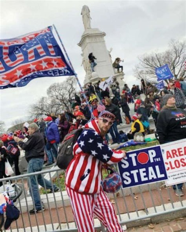 Jan. 6 rioter holding 'stop the steal' sign swung at officers with a Trump flag, FBI says