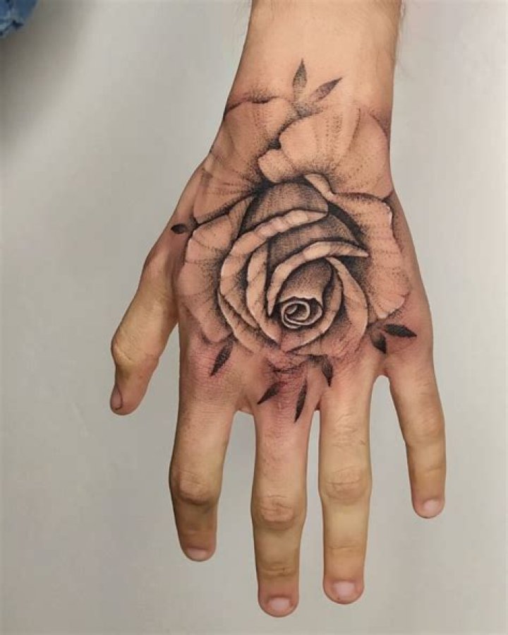 Embodying Beauty And Strength: The Rose In Hand Tattoo